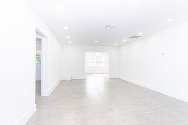 spare room with a chandelier and a wealth of natural light