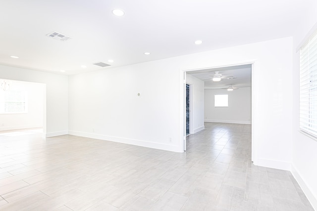 empty room featuring light wood-type flooring and ceiling fan