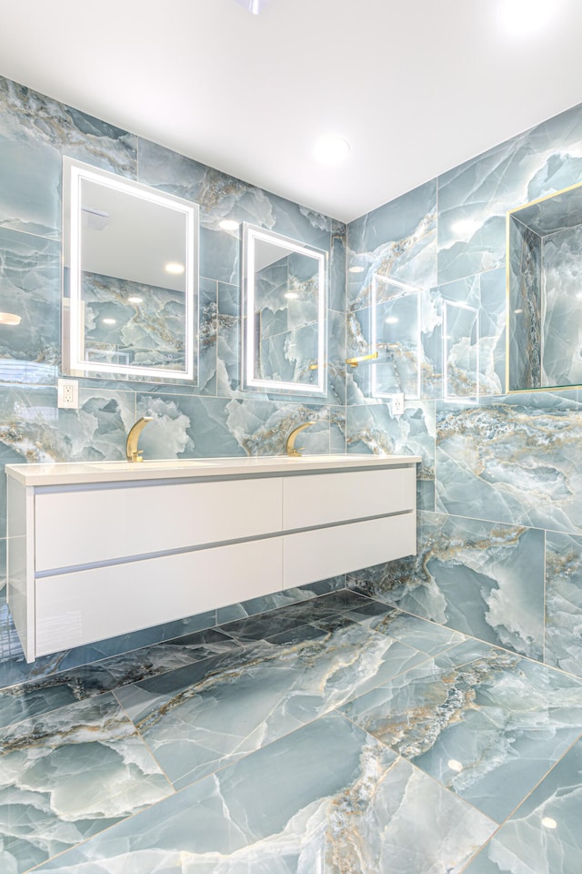 bathroom featuring vanity and tile walls