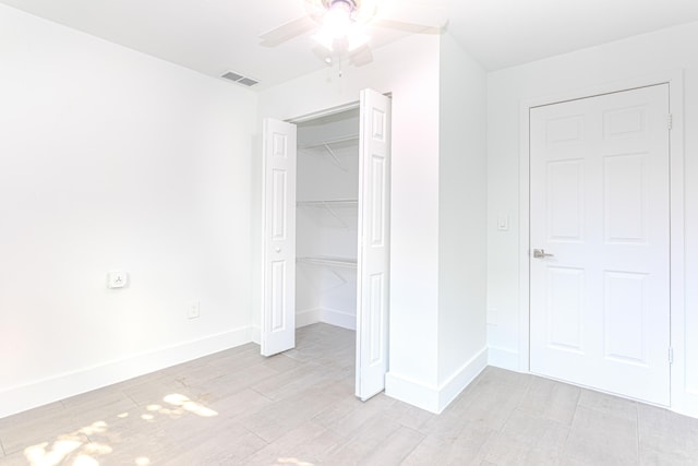 unfurnished bedroom featuring a closet and ceiling fan