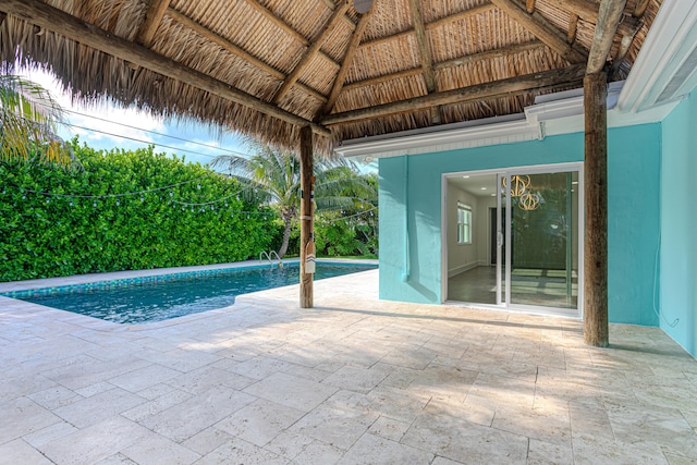 view of swimming pool featuring a patio and a gazebo