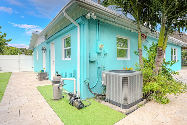 view of side of home featuring a patio and central AC