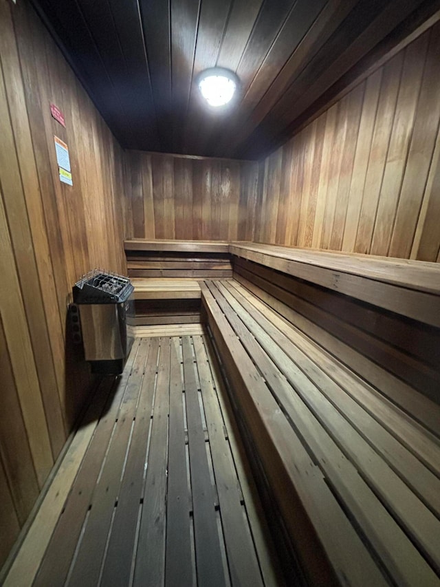 view of sauna with wood walls