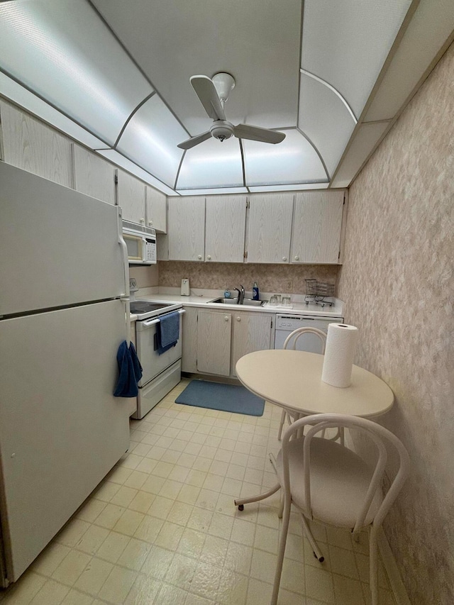 kitchen featuring ceiling fan, white cabinets, sink, white appliances, and washer / clothes dryer