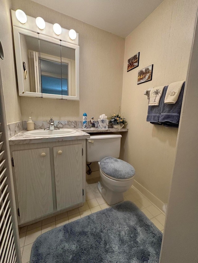 bathroom with vanity, toilet, and tile patterned floors