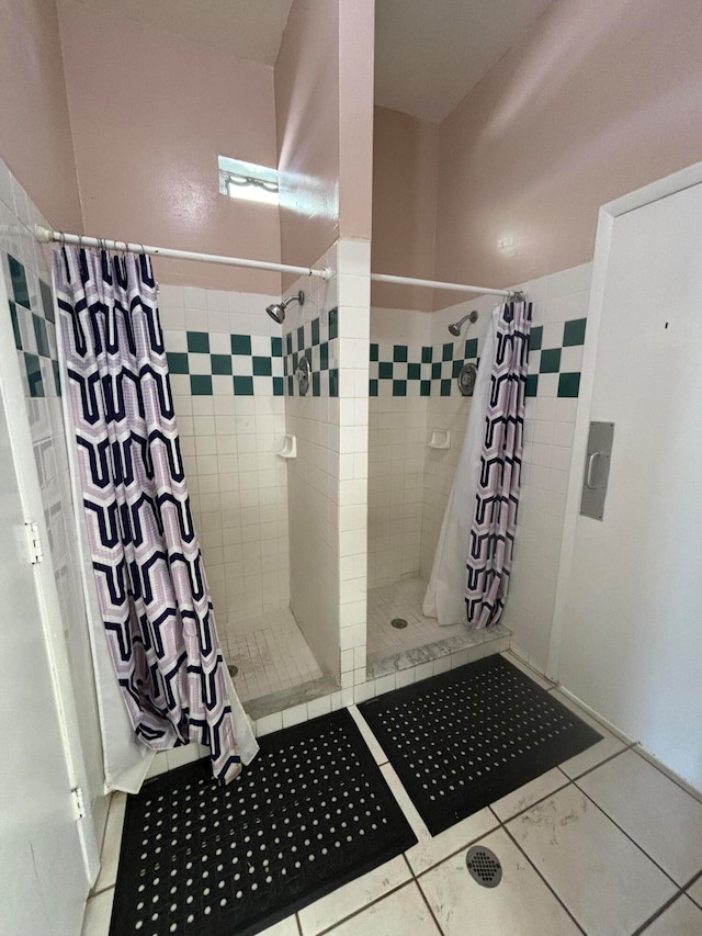 bathroom featuring curtained shower and tile patterned floors