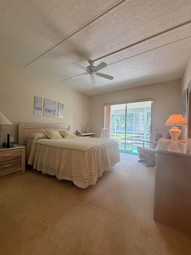 bedroom with ceiling fan, light colored carpet, a textured ceiling, and access to exterior