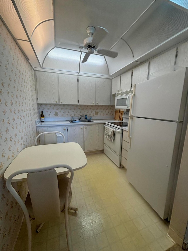 kitchen featuring ceiling fan, white appliances, sink, and white cabinets