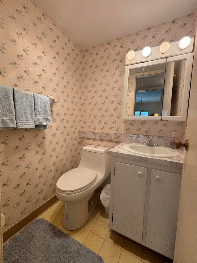 bathroom with tile patterned flooring, vanity, and toilet