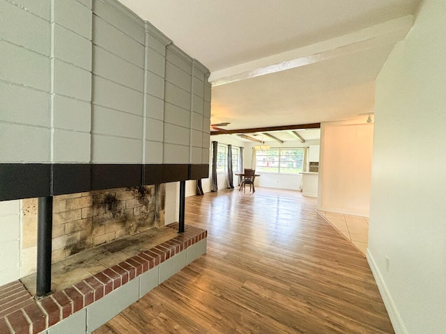 hall with wood-type flooring and beamed ceiling