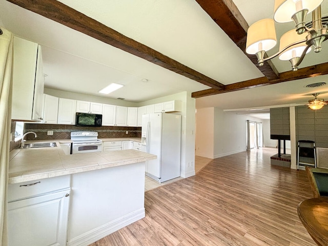 kitchen featuring light wood-type flooring, sink, white cabinets, decorative backsplash, and white appliances