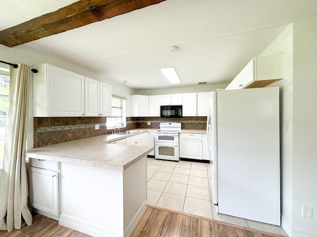 kitchen with white cabinetry, backsplash, white appliances, light wood-type flooring, and sink