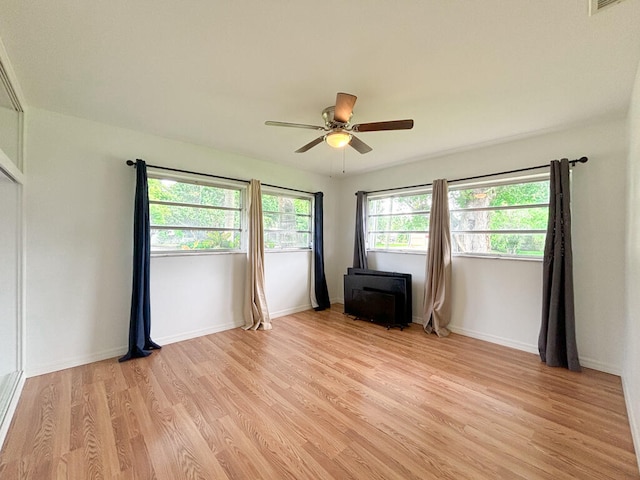 unfurnished room featuring ceiling fan and light hardwood / wood-style flooring