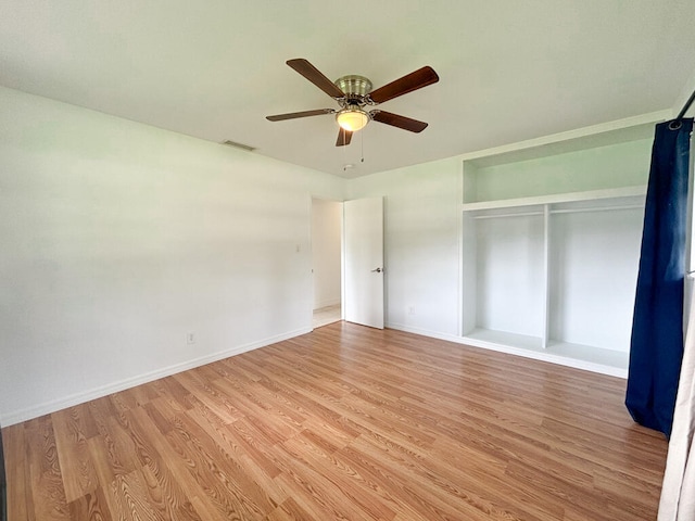 unfurnished bedroom featuring a closet, light wood-type flooring, and ceiling fan