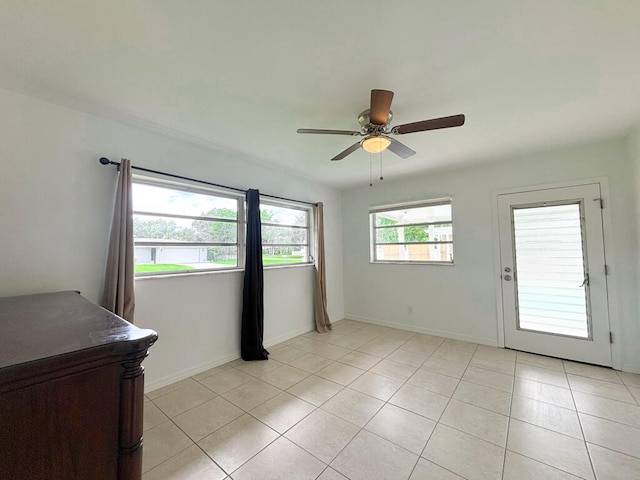 tiled empty room with ceiling fan