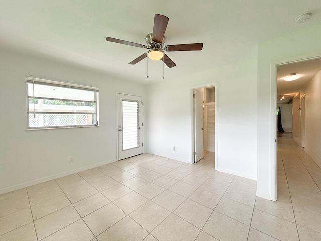 unfurnished room featuring ceiling fan and light tile patterned floors