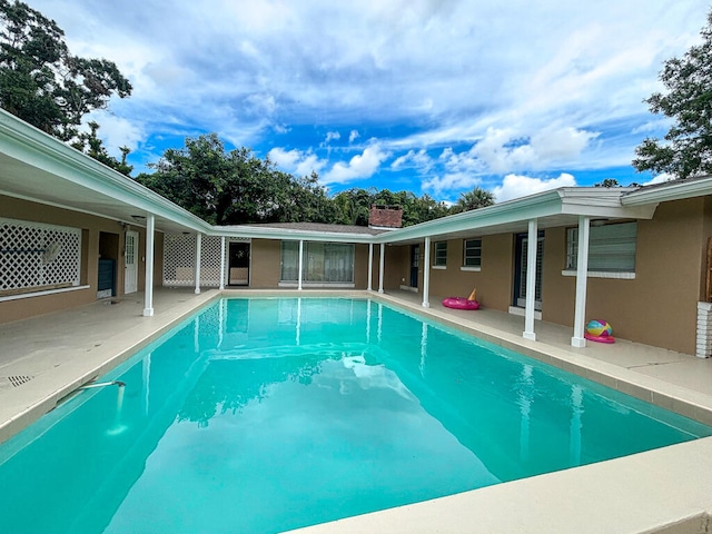 view of swimming pool with a patio