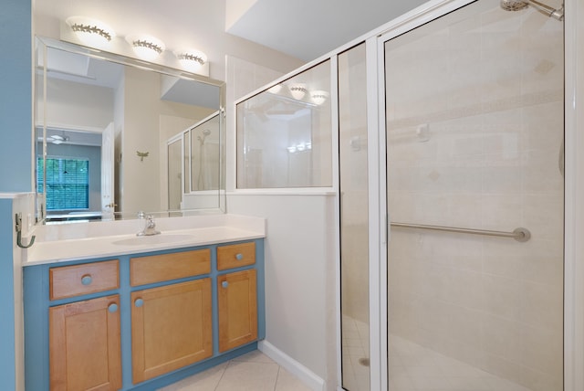 bathroom with walk in shower, vanity, and tile patterned floors