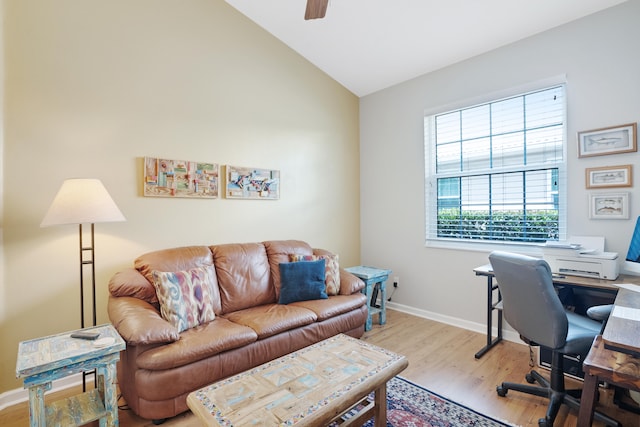 office space featuring vaulted ceiling and light hardwood / wood-style flooring