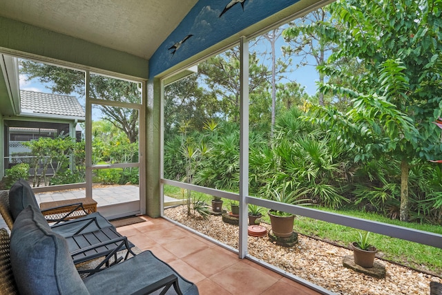 unfurnished sunroom featuring vaulted ceiling