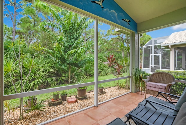 sunroom featuring vaulted ceiling