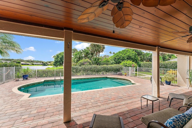 view of swimming pool with ceiling fan and a patio