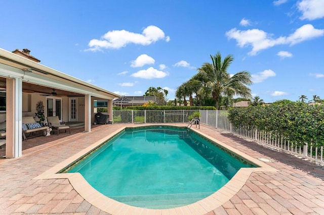 view of swimming pool with ceiling fan and a patio area