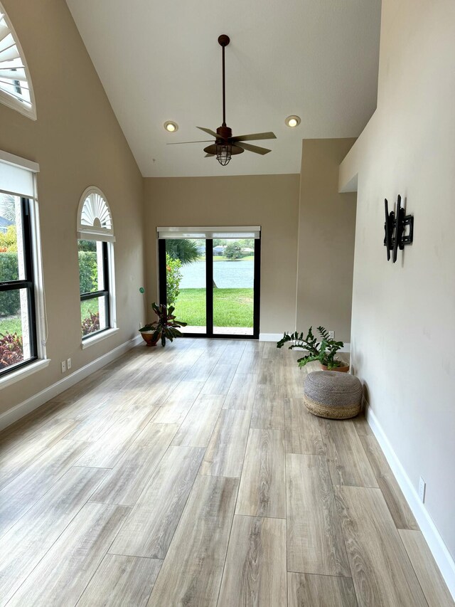 living room with high vaulted ceiling, indoor wet bar, light tile patterned floors, and beverage cooler