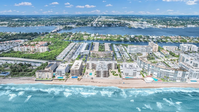 drone / aerial view featuring a water view and a view of the beach