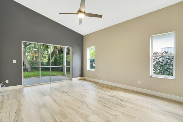 unfurnished room with ceiling fan, light hardwood / wood-style flooring, high vaulted ceiling, and a wealth of natural light