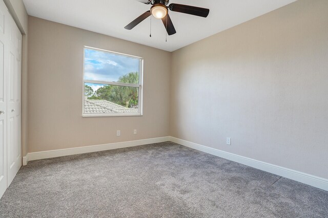 carpeted empty room with ceiling fan