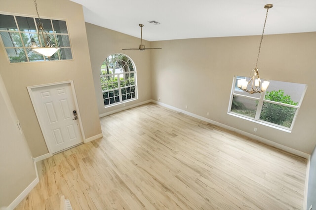 unfurnished living room featuring a notable chandelier, light wood-type flooring, and high vaulted ceiling