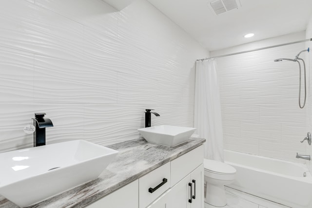 full bathroom featuring shower / tub combo, vanity, and toilet