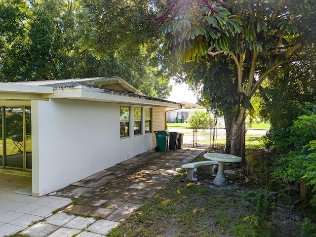 view of side of property featuring a patio area