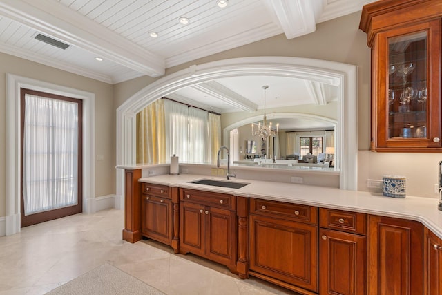 interior space featuring an inviting chandelier, sink, beamed ceiling, and plenty of natural light