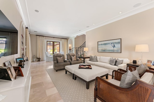 living room with ornamental molding and french doors