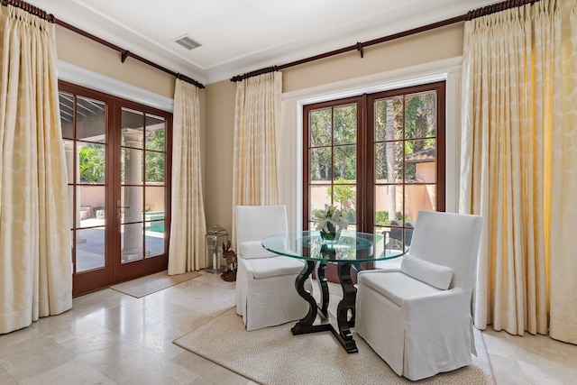 dining room with french doors and crown molding