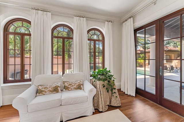 living room with a wealth of natural light, hardwood / wood-style floors, and french doors