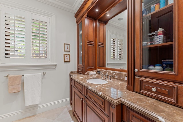 bathroom featuring vanity, tile patterned floors, and crown molding