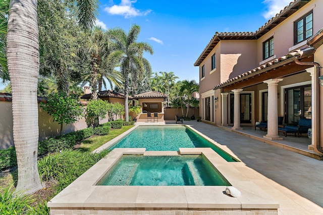 view of swimming pool with an in ground hot tub and a patio area