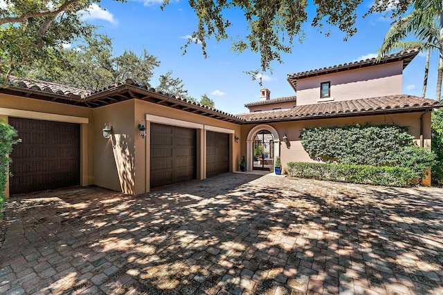 mediterranean / spanish-style home with a garage