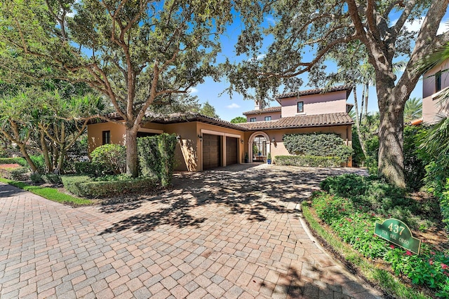 mediterranean / spanish home with a garage