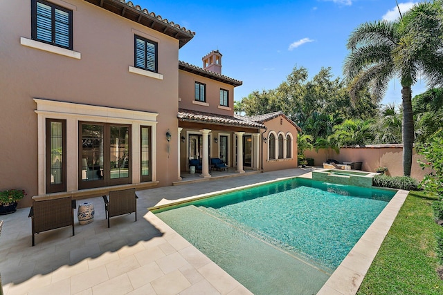 view of pool with a patio and an in ground hot tub