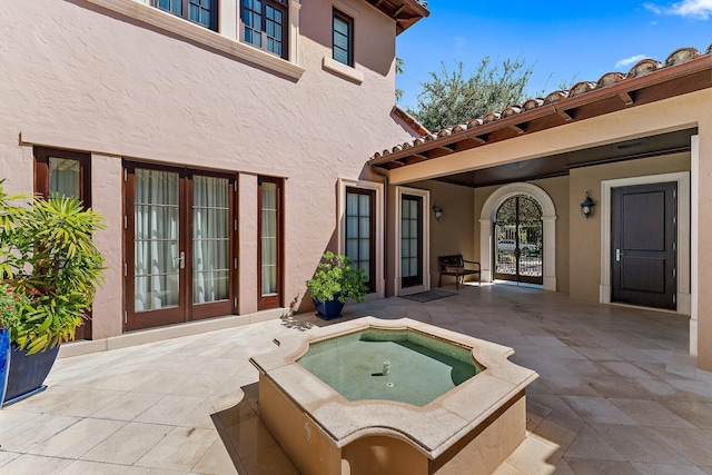 view of patio / terrace with an in ground hot tub