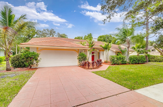 view of front of house with a front lawn and a garage