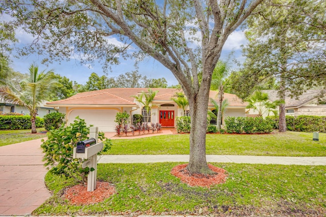 view of front facade with a front yard and a garage