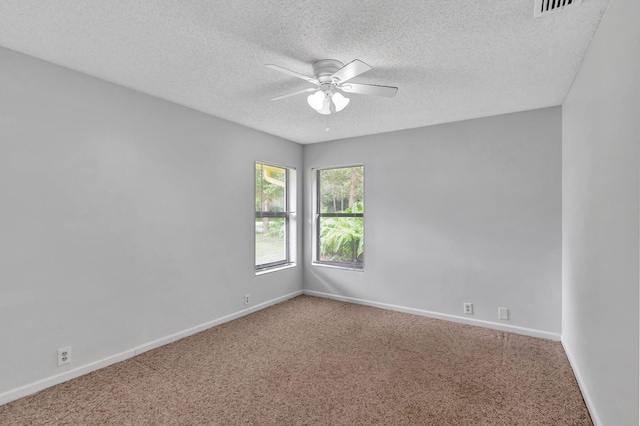 unfurnished room with a textured ceiling, carpet, and ceiling fan