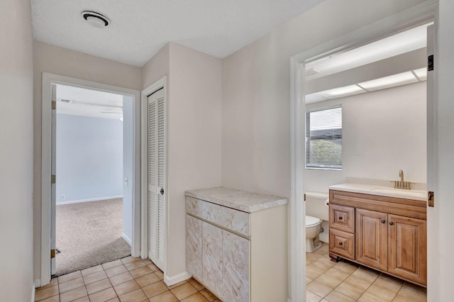 bathroom with vanity, toilet, and tile patterned floors