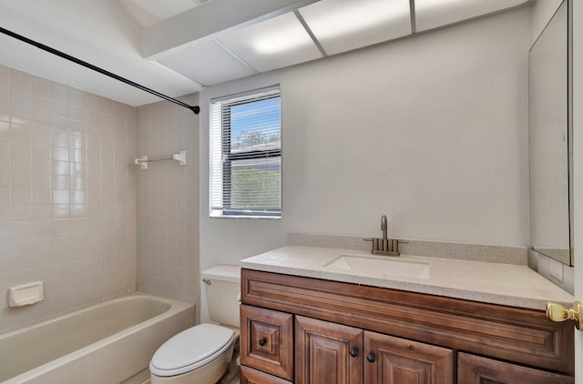 full bathroom featuring tiled shower / bath combo, vanity, and toilet