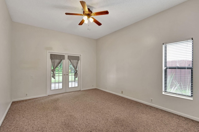 empty room with carpet, ceiling fan, and plenty of natural light